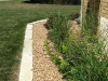Substantial limestone edging cleanly defines the bed and complements the architecture.