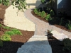 You can see fresh brickwork, natural stone steps, and erosion matting to re-grow turf.